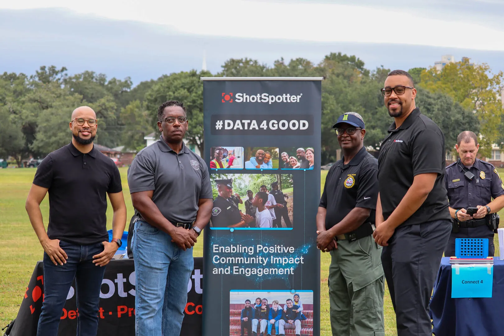 a group of men standing next to a sign