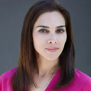 a woman in a pink shirt posing for a picture