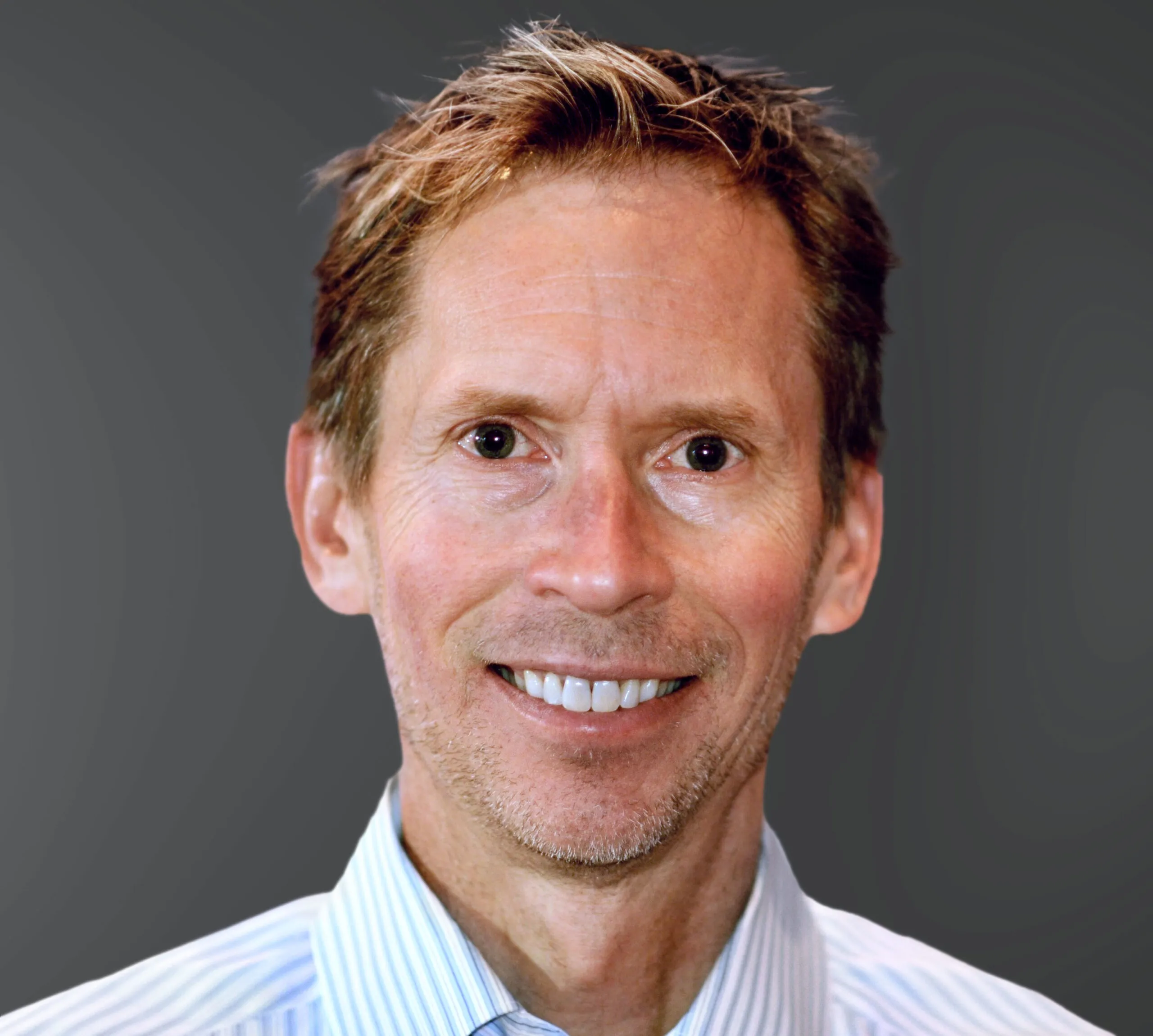 a man wearing a blue striped shirt and tie