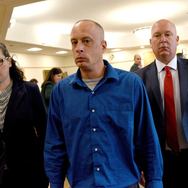 Plaintiff David Meehan, center, leaves the courtroom with his attorney Rus Rilee, right, and victim specialist Joelle Wiggin during Meehan's trial at Rockingham Superior Court in Brentwood, N.H., April 10, 2024. The jury found the state liable for abuse at its youth detention center and awarded the sum to Meehan, a former resident who says he was beaten and raped as a teen. (David Lane/Pool Photo via AP)