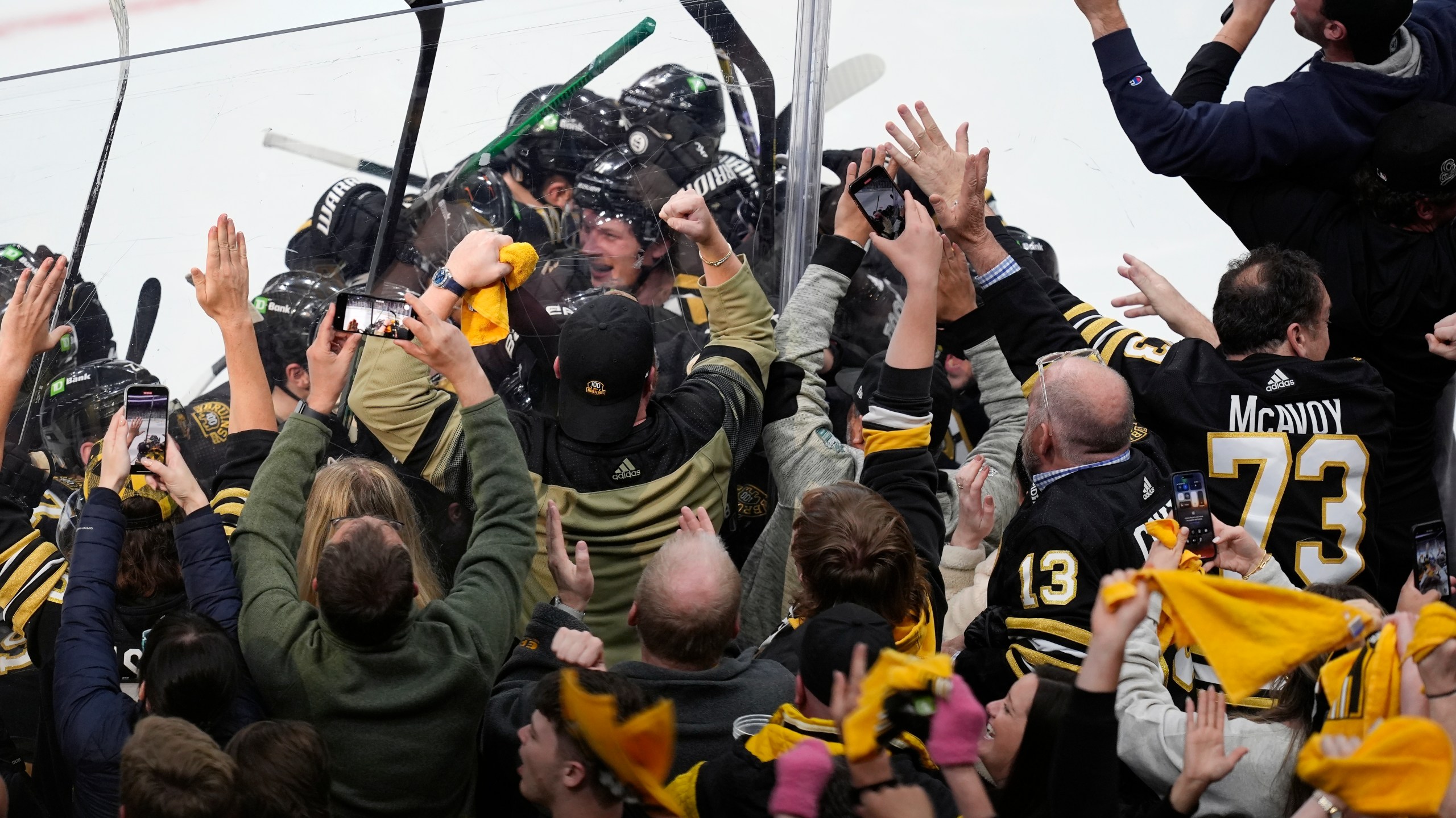 Fans celebrate after the Boston Bruins defeated the Toronto Maple Leafs in overtime during Game 7 of an NHL hockey Stanley Cup first-round playoff series, Saturday, May 4, 2024, in Boston. (AP Photo/Michael Dwyer)