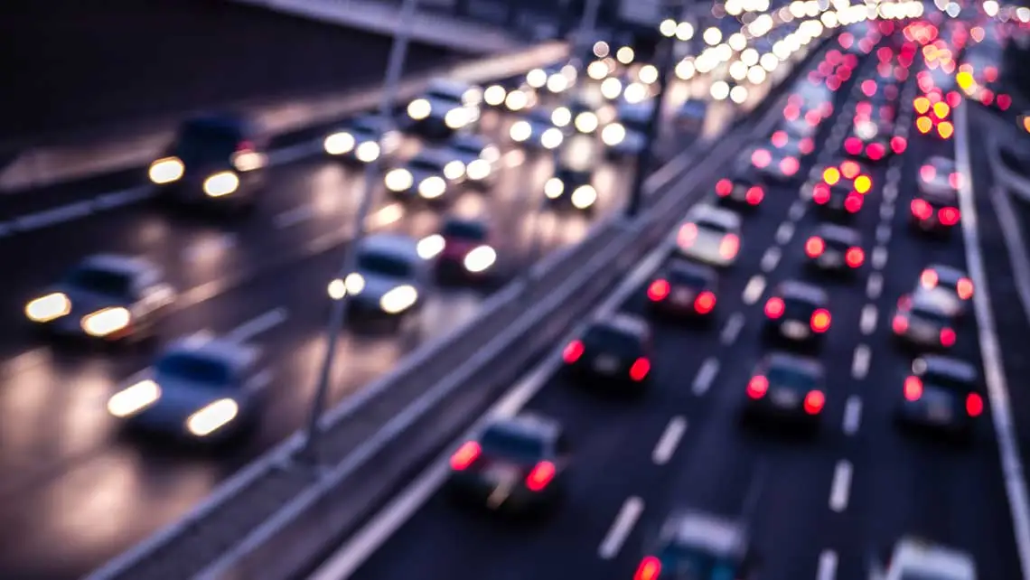 a highway filled with lots of traffic at night