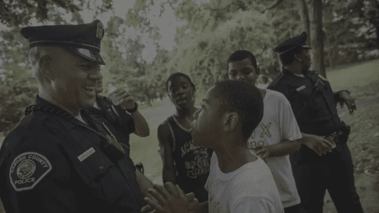 a police officer talking to a young boy