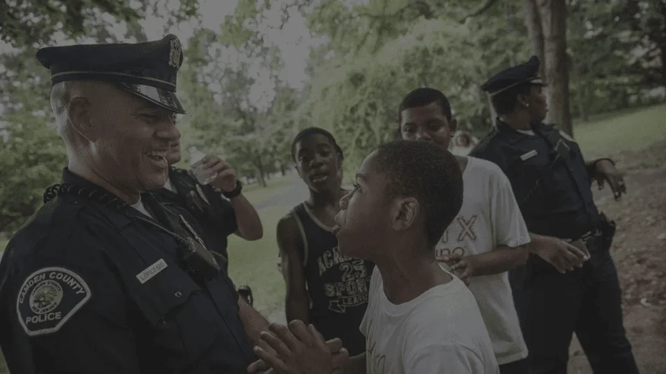 a police officer talking to a young boy