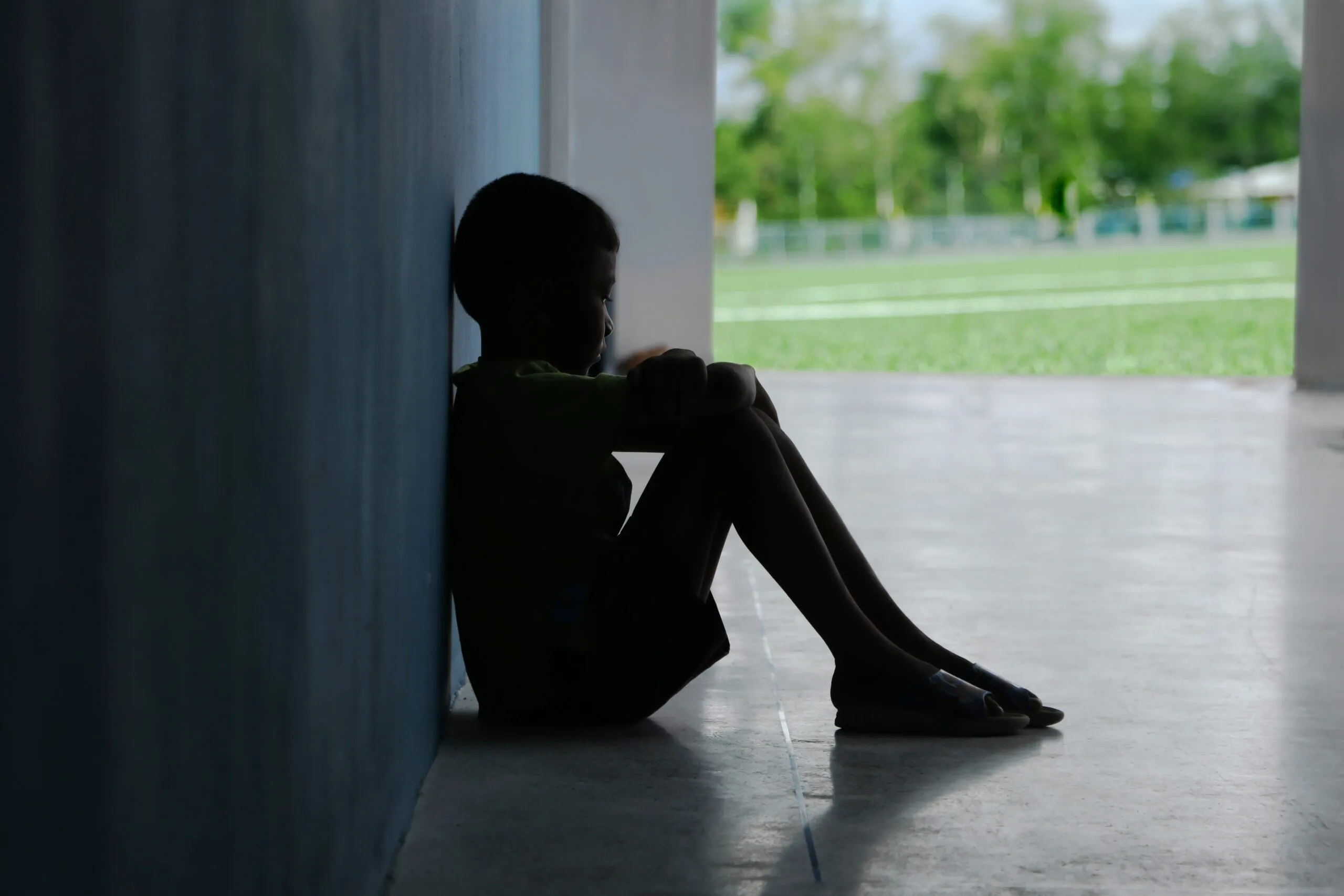 a person sitting on the floor with their legs crossed