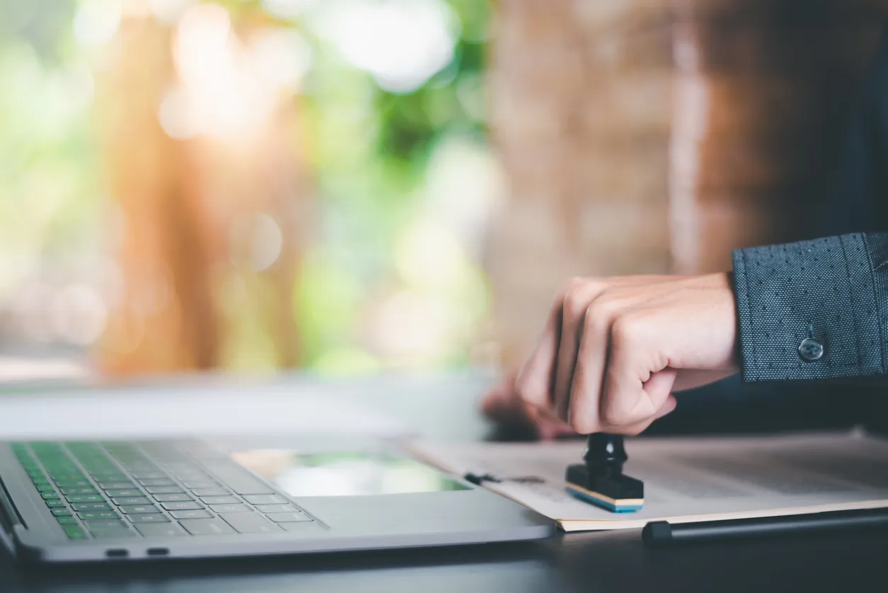 a person is typing on a laptop computer