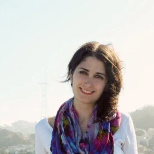 a woman wearing a colorful scarf and a white shirt