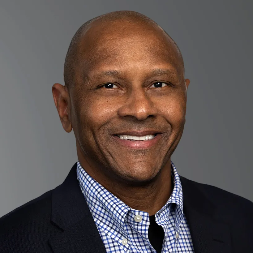 a man in a suit smiling for a picture