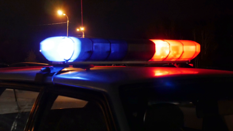 a police car with its lights on at night