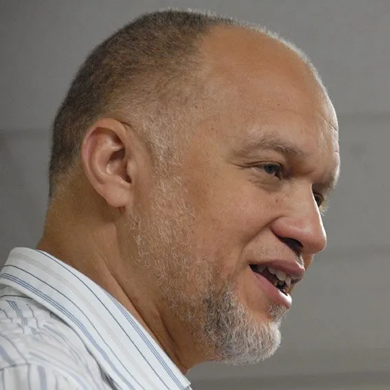 a close up of a person wearing a suit and tie