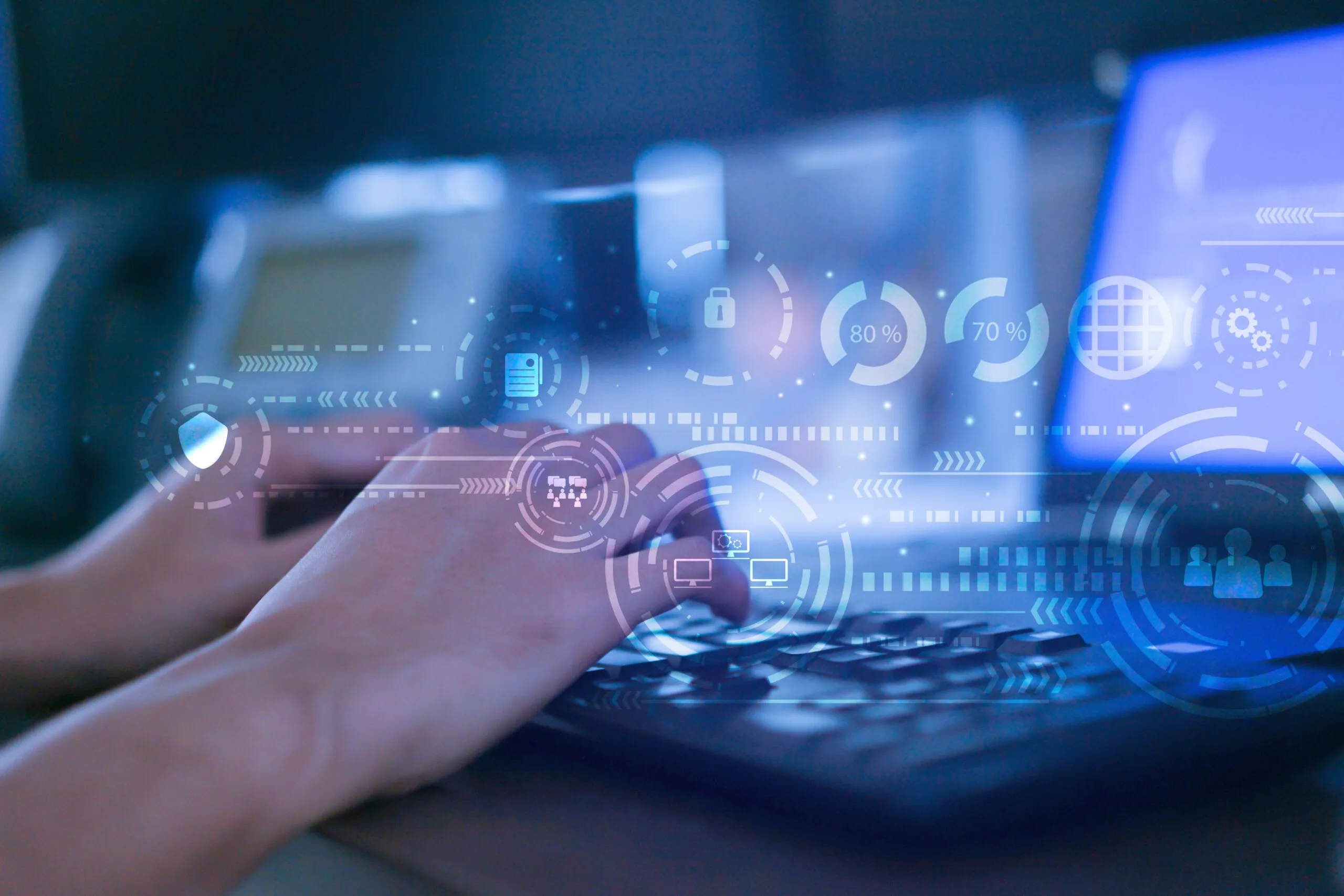 a person typing on a laptop with a futuristic interface