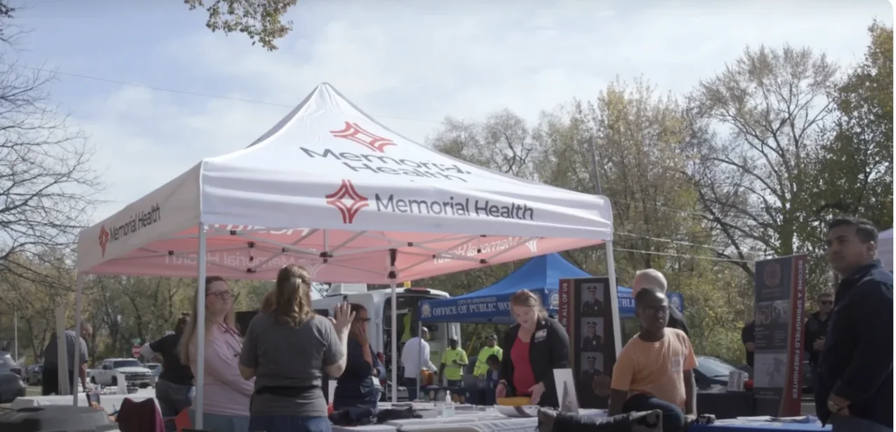 a group of people standing under a tent